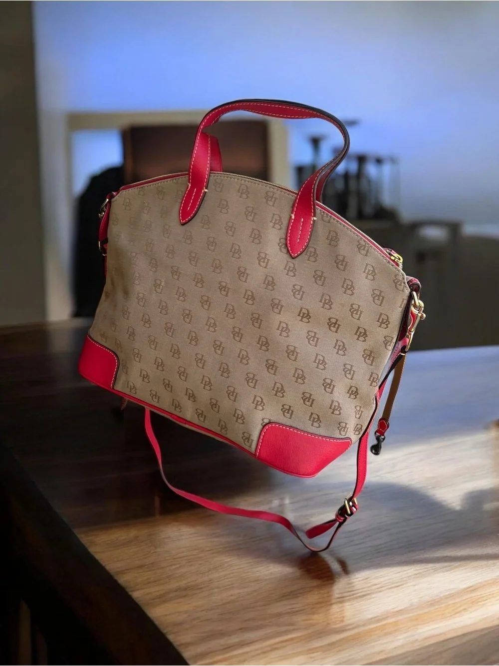 Dooney & Bourke Signature monogram satchel features vibrant pink leather trim